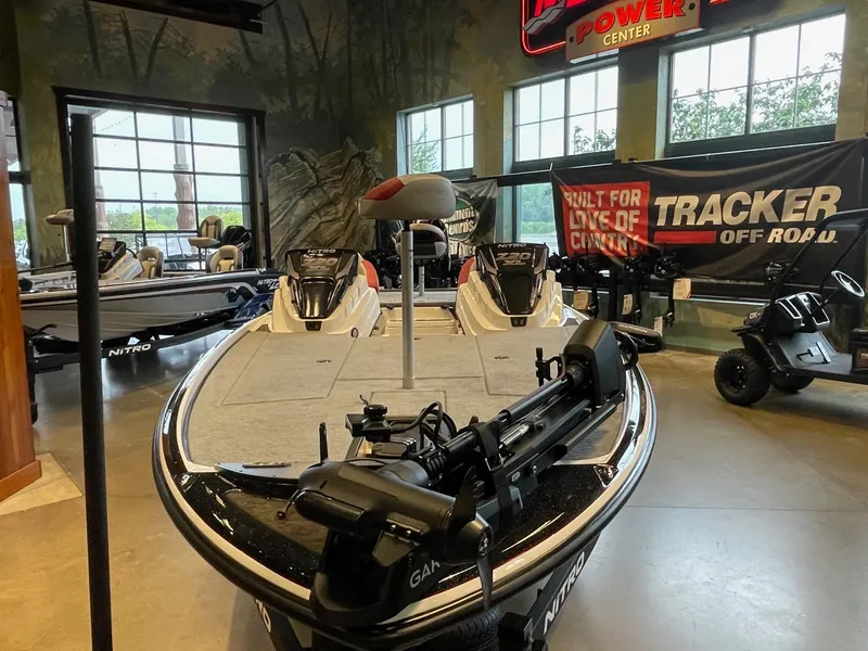 Slide: The Image of 2025 Nitro Z20 XL Pro boat displayed indoors with fishing equipment and promotional banners. - 1