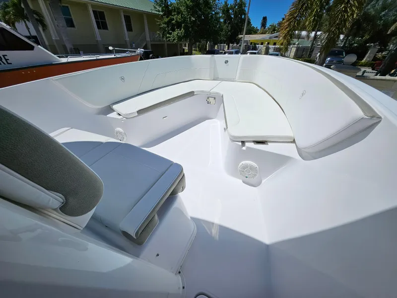 Slide: The Image of Century 2900 Center Console 2022 boat interior with white seating and spacious deck. - 15