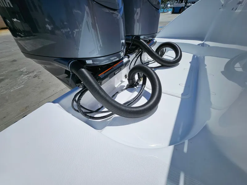 Slide: The Image of 2022 Century 2900 Center Console boat with dual outboard motors and coiled cables. - 41