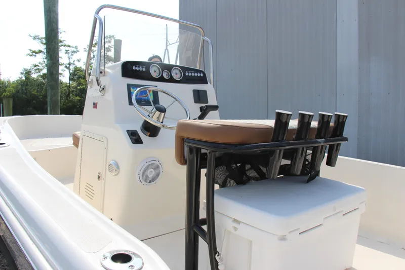 Slide: The Image of 2025 Pioneer 180 Sportfish boat interior with steering console and seating. - 6