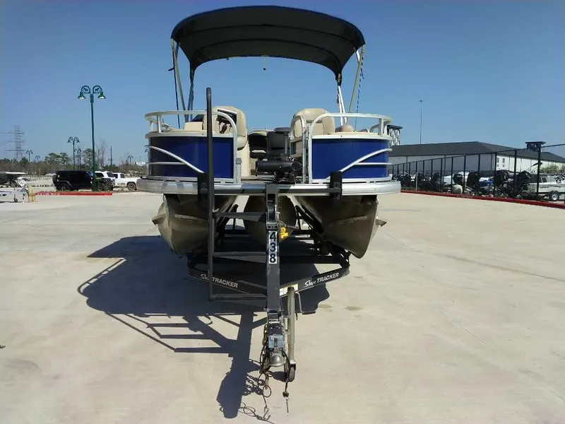 Slide: The Image of 2017 Sun Tracker Fishing Barge 22 XP3 pontoon boat on trailer, parked outdoors. - 5