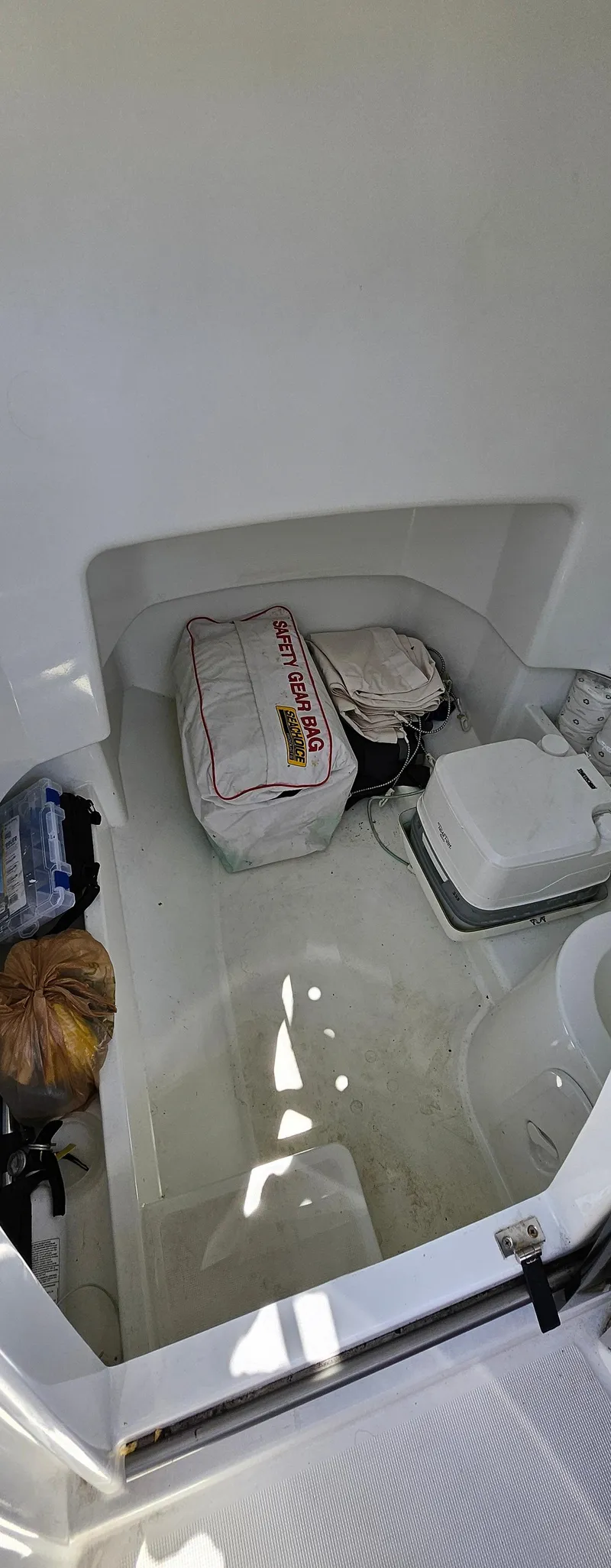 Slide: The Image of Storage compartment of 2019 Jeanneau Leader 7.5 CC boat with various items. - 5