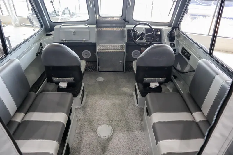 Slide: The Image of 2025 Hewescraft 240 Ocean Pro ET HT boat interior with seating and steering console. - 12