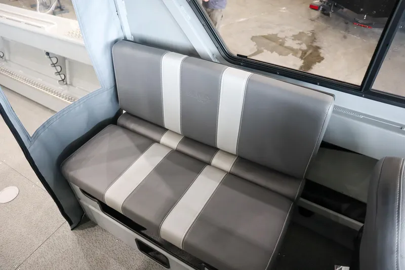 Slide: The Image of 2025 Hewescraft 240 Ocean Pro ET HT interior seating with gray and white upholstery. - 13