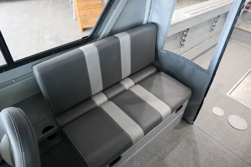 Slide: The Image of 2025 Hewescraft 240 Ocean Pro ET HT interior seating, featuring gray and black upholstery. - 14