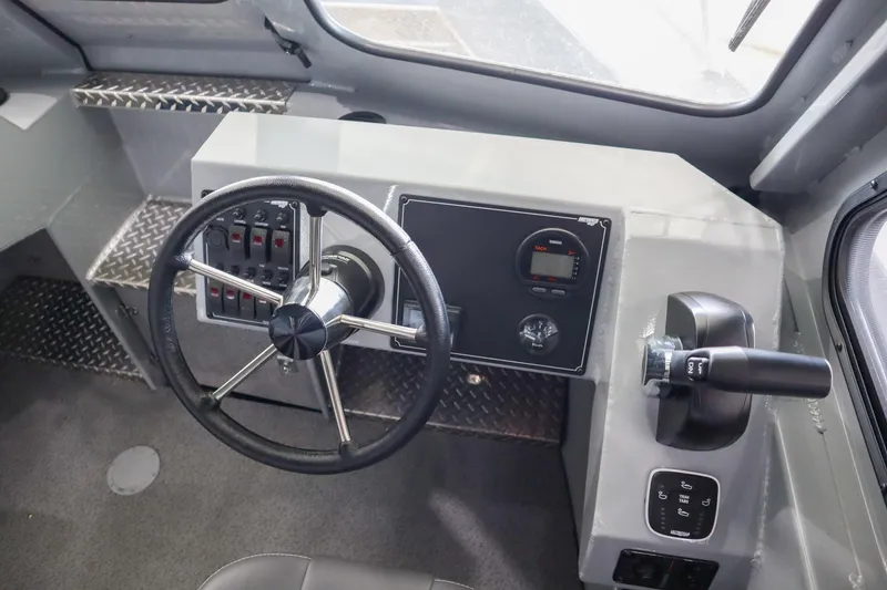 Slide: The Image of 2025 Hewescraft 240 Ocean Pro ET HT boat dashboard with steering wheel and controls. - 17