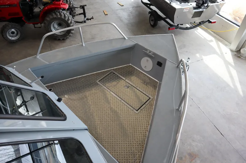 Slide: The Image of 2025 Hewescraft 240 Ocean Pro ET HT boat interior with diamond plate flooring. - 19