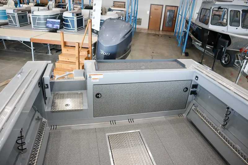 Slide: The Image of 2025 Hewescraft 240 Ocean Pro ET HT boat interior, showcasing spacious deck and storage compartments. - 6