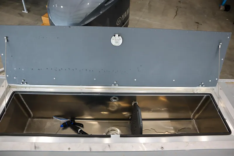 Slide: The Image of Livewell on 2025 Hewescraft 240 Ocean Pro ET HT boat, featuring stainless steel interior. - 8