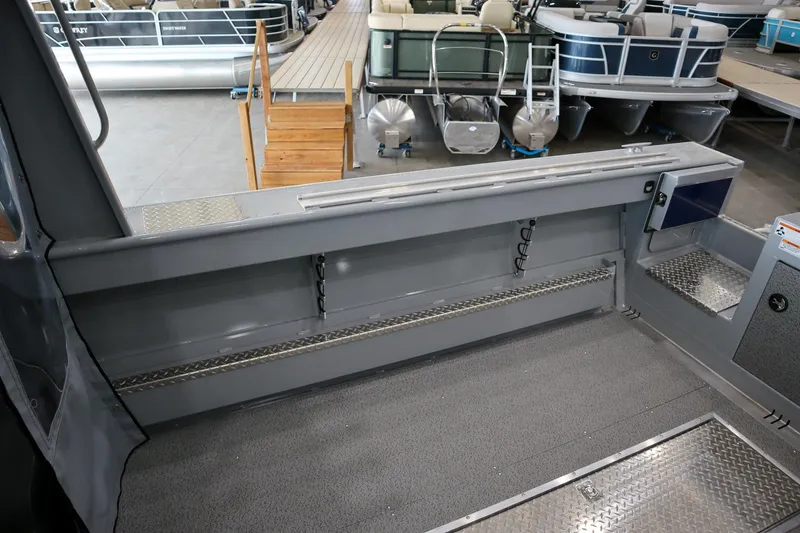 Slide: The Image of 2025 Hewescraft 240 Ocean Pro ET HT boat interior with spacious deck and storage features. - 9
