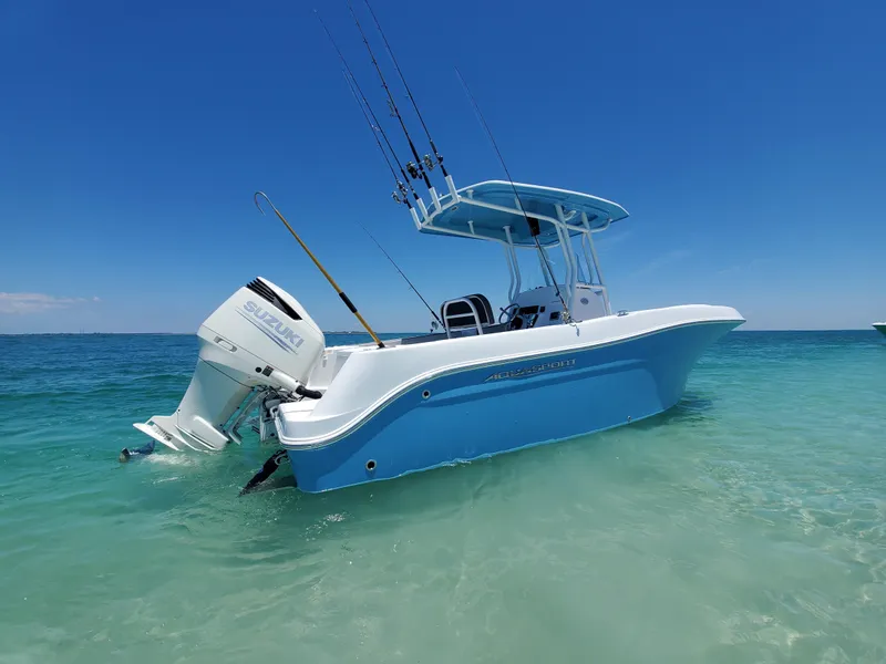 Slide: The Image of 2022 Aquasport 2300 Center Console boat in clear blue water under a sunny sky. - 1