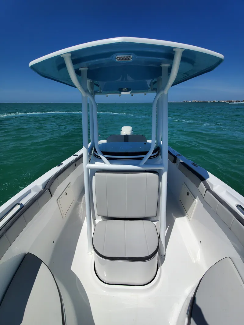 Slide: The Image of 2022 Aquasport 2300 Center Console boat on open water, featuring sleek design and spacious seating. - 8