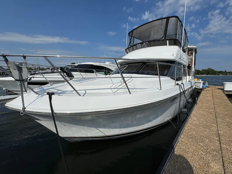 Slide: The Image of 2000 Carver 406 Aft Cabin Motor Yacht docked at marina under clear sky. - 11