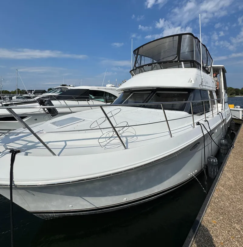 Slide: The Image of 2000 Carver 406 Aft Cabin Motor Yacht docked at marina under blue sky. - 12