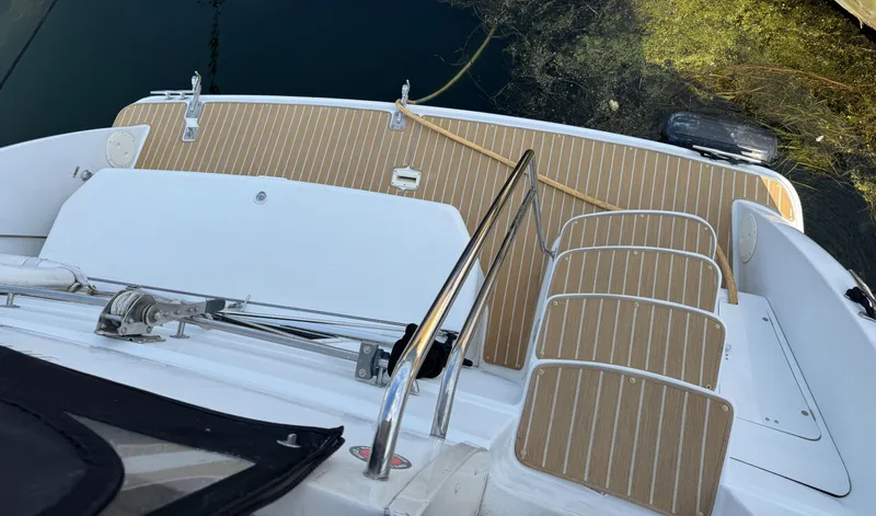 Slide: The Image of Carver 406 Aft Cabin Motor Yacht 2000, deck view with wooden flooring and railing. - 13