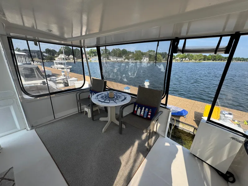 Slide: The Image of Spacious interior of 2000 Carver 406 Aft Cabin Motor Yacht with waterfront view. - 19