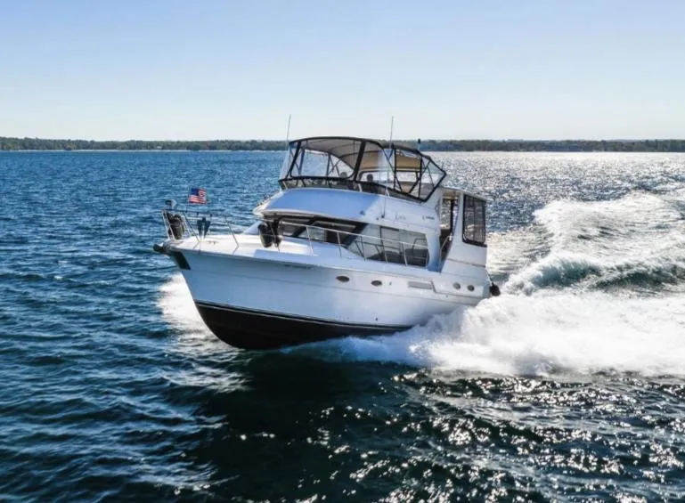 Slide: The Image of 2000 Carver 406 Aft Cabin Motor Yacht cruising on open water. - 2