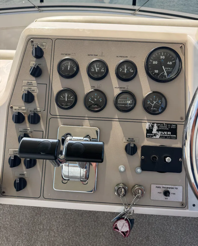 Slide: The Image of Control panel of a 2000 Carver 406 Aft Cabin Motor Yacht with gauges and switches. - 26