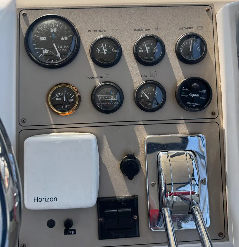 Slide: The Image of Control panel of a 2000 Carver 406 Aft Cabin Motor Yacht with gauges and throttle levers. - 27
