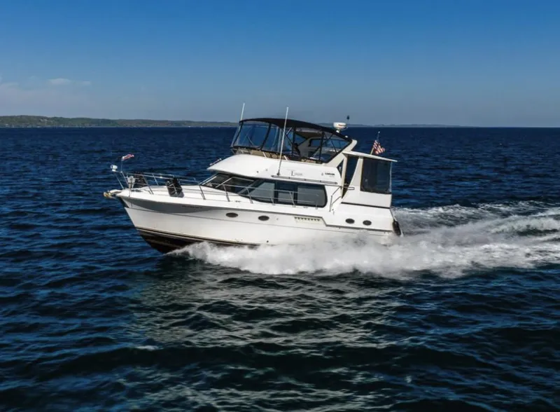 Slide: The Image of 2000 Carver 406 Aft Cabin Motor Yacht cruising on open water. - 3