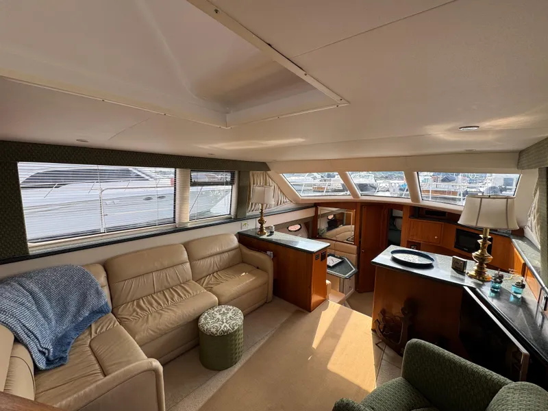 Slide: The Image of Interior of 2000 Carver 406 Aft Cabin Motor Yacht with beige seating and wooden accents. - 31