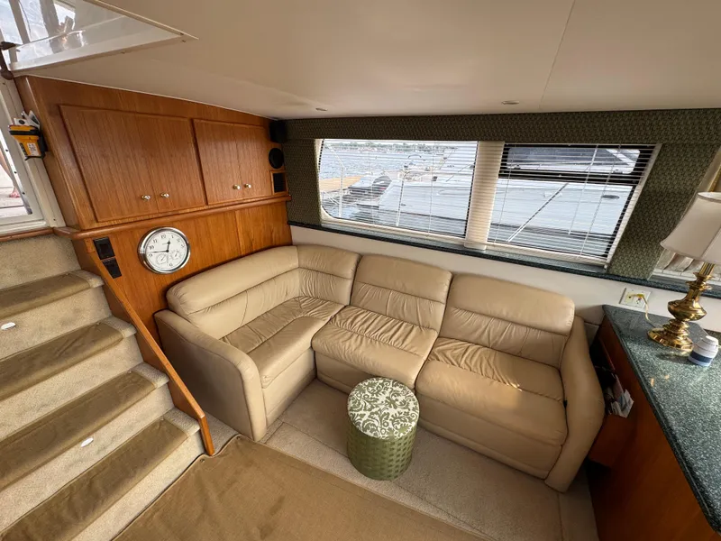 Slide: The Image of Interior of 2000 Carver 406 Aft Cabin Motor Yacht with beige sofa and wooden cabinetry. - 32