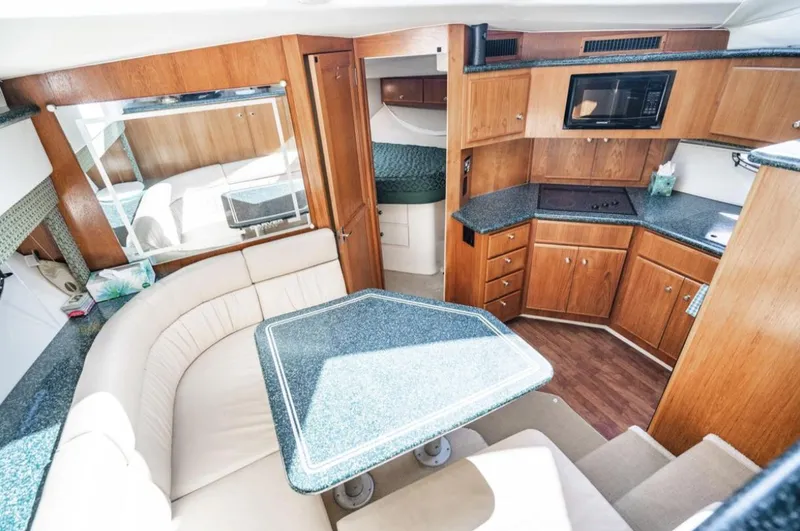 Slide: The Image of Interior of 2000 Carver 406 Aft Cabin Motor Yacht with dining area and kitchen. - 38