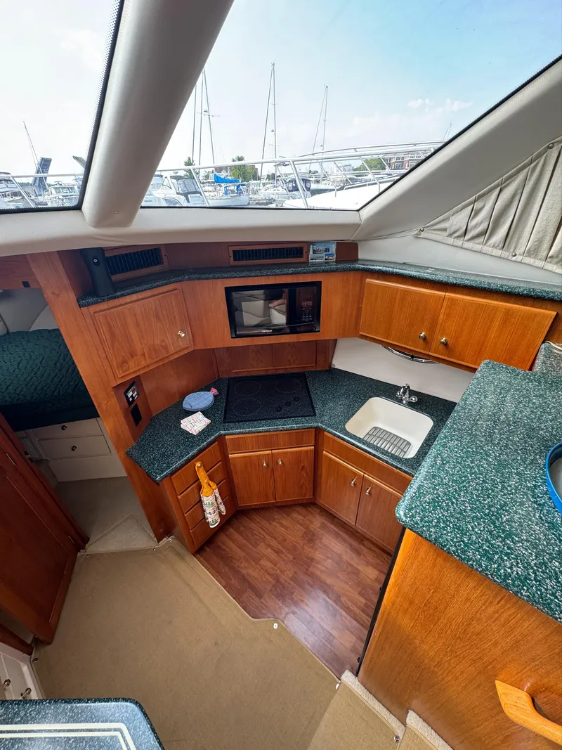 Slide: The Image of Interior of 2000 Carver 406 Aft Cabin Motor Yacht with modern kitchen amenities. - 39
