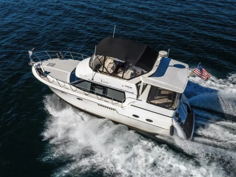 Slide: The Image of 2000 Carver 406 Aft Cabin Motor Yacht cruising on open water. - 4