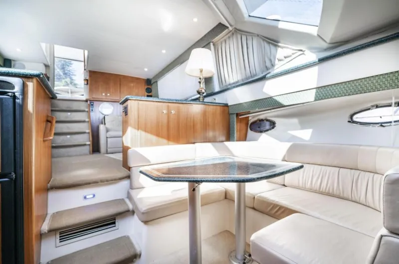 Slide: The Image of Luxurious interior of 2000 Carver 406 Aft Cabin Motor Yacht with elegant seating and table. - 42
