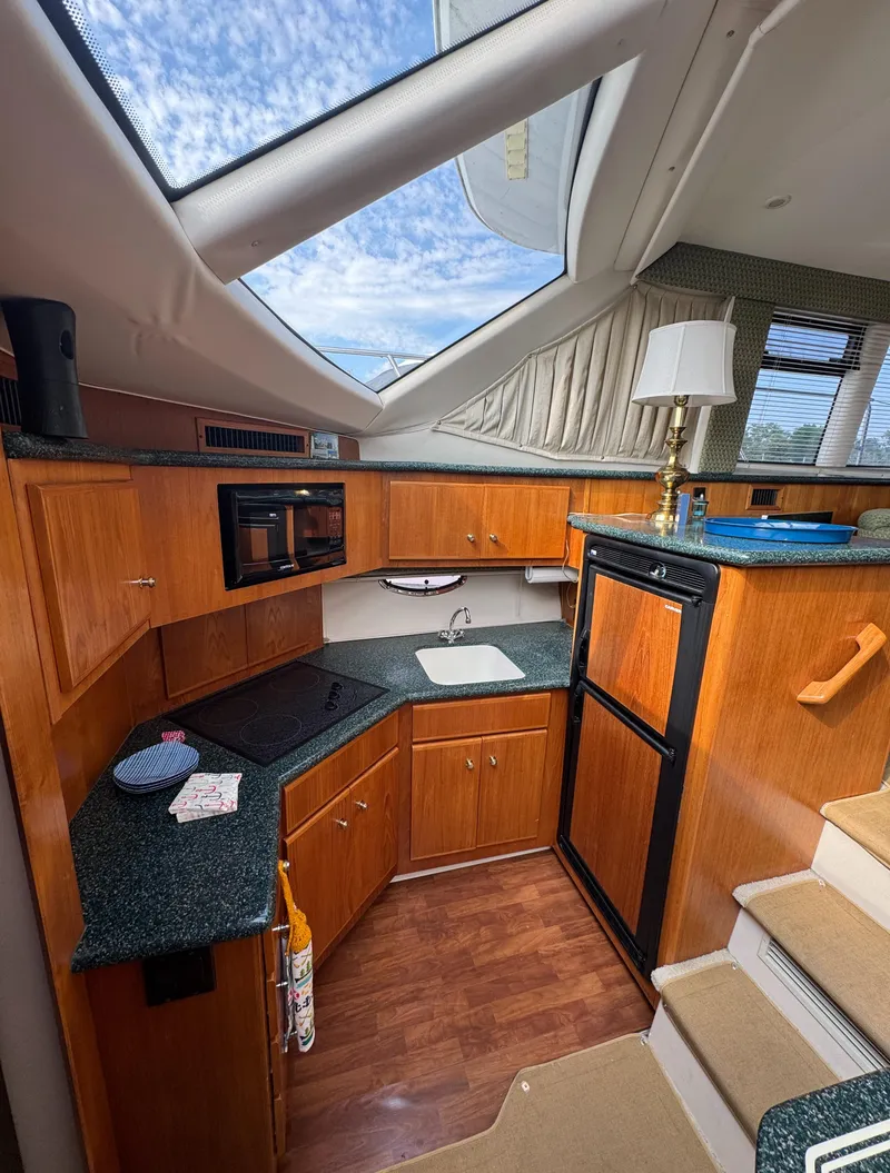 Slide: The Image of Interior of 2000 Carver 406 Aft Cabin Motor Yacht with modern kitchen amenities. - 44
