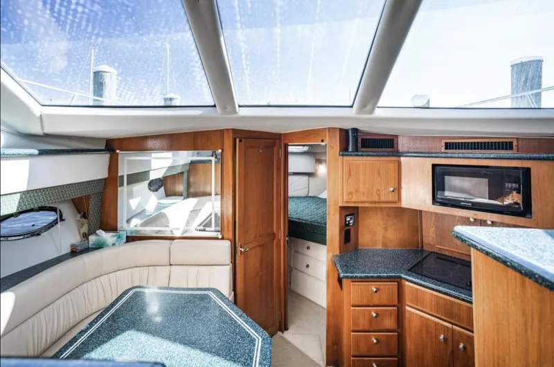 Slide: The Image of Interior of 2000 Carver 406 Aft Cabin Motor Yacht with modern kitchen and seating area. - 46