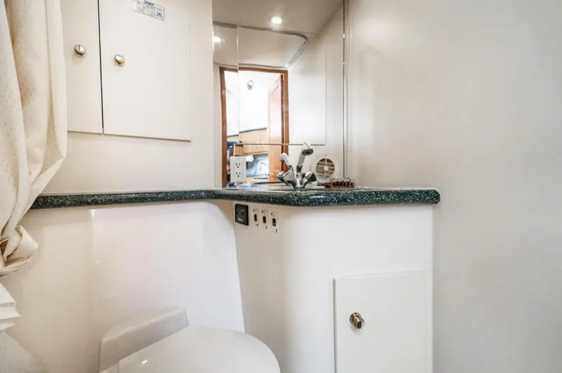 Slide: The Image of Interior of 2000 Carver 406 Aft Cabin Motor Yacht bathroom with sink and storage. - 48