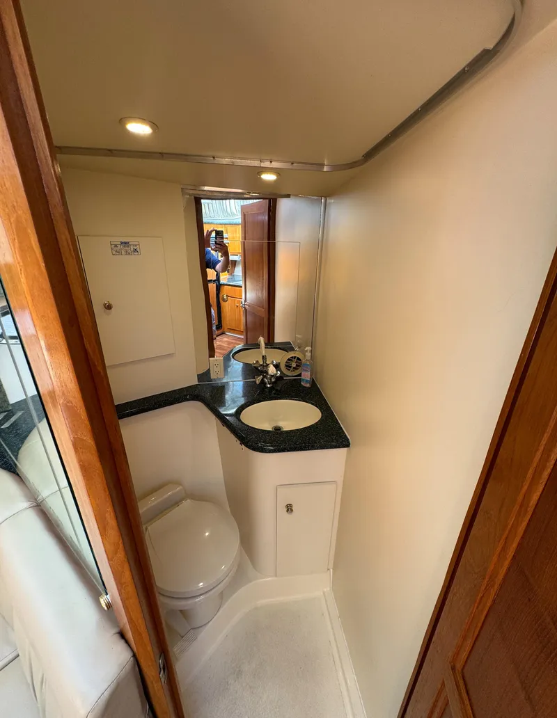 Slide: The Image of 2000 Carver 406 Aft Cabin Motor Yacht bathroom with sink and toilet. - 49