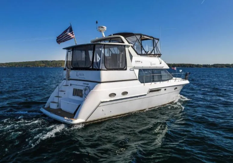 Slide: The Image of 2000 Carver 406 Aft Cabin Motor Yacht cruising on open water. - 7