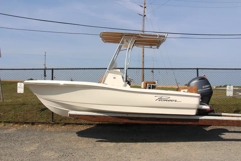 Slide: The Image of 2025 Pioneer 180 Islander boat on trailer, side view, outdoors. - 1