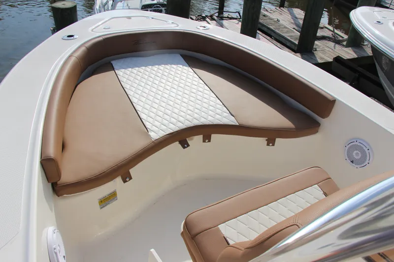 Slide: The Image of 2025 Pioneer 180 Islander boat with tan and white cushioned seating. - 12