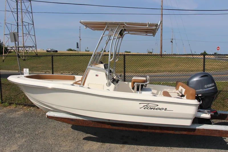 Slide: The Image of 2025 Pioneer 180 Islander boat with Yamaha engine, parked on a trailer. - 2