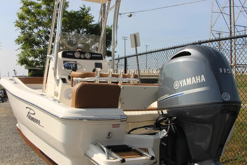 Slide: The Image of 2025 Pioneer 180 Islander boat with Yamaha 115 engine, docked near a fence. - 5