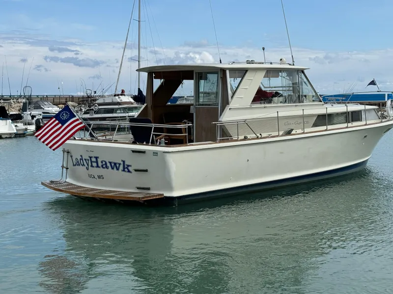 Slide: The Image of 1969 Chris-Craft Commander boat named LadyHawk docked in a marina. - 12