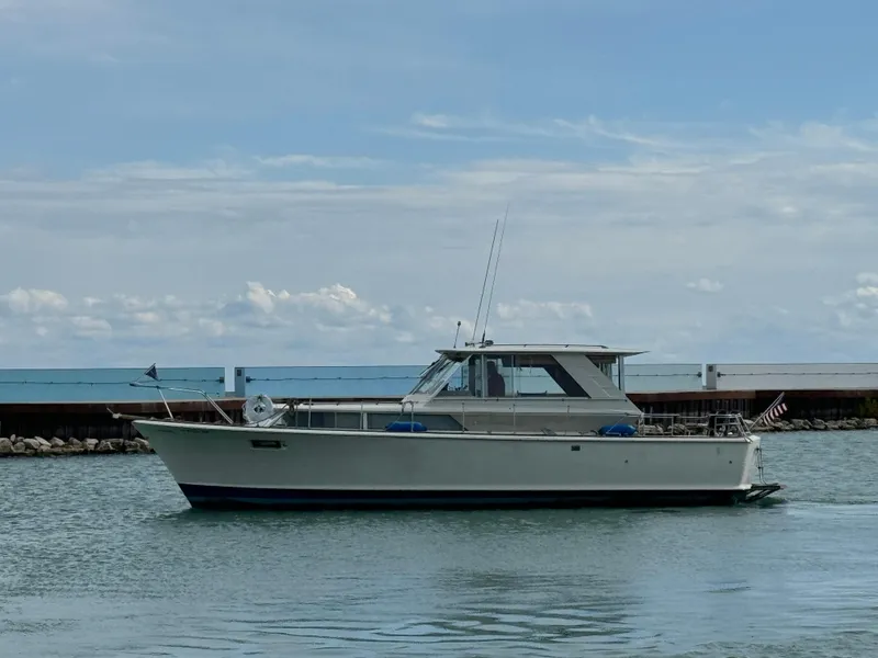 Slide: The Image of 1969 Chris-Craft Commander boat cruising on calm waters under a clear sky. - 27