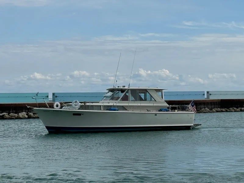 Slide: The Image of 1969 Chris-Craft Commander boat on calm water, clear sky background. - 28