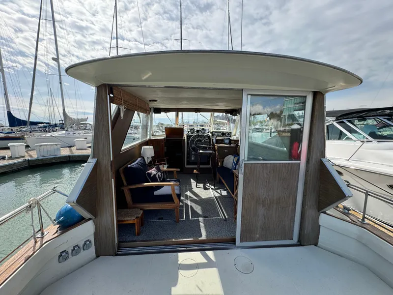 Slide: The Image of 1969 Chris-Craft Commander yacht interior with seating and helm, docked at marina. - 43