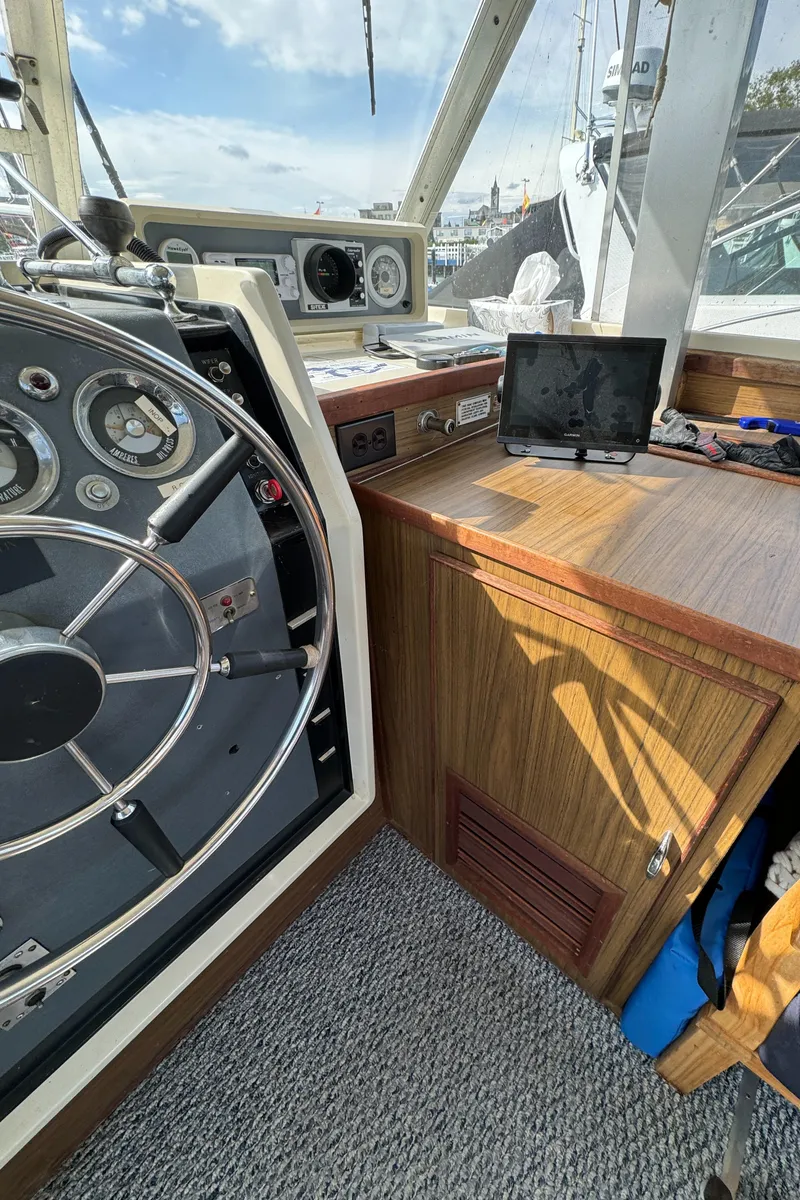 Slide: The Image of 1969 Chris-Craft Commander boat interior with steering wheel and wooden dashboard. - 48