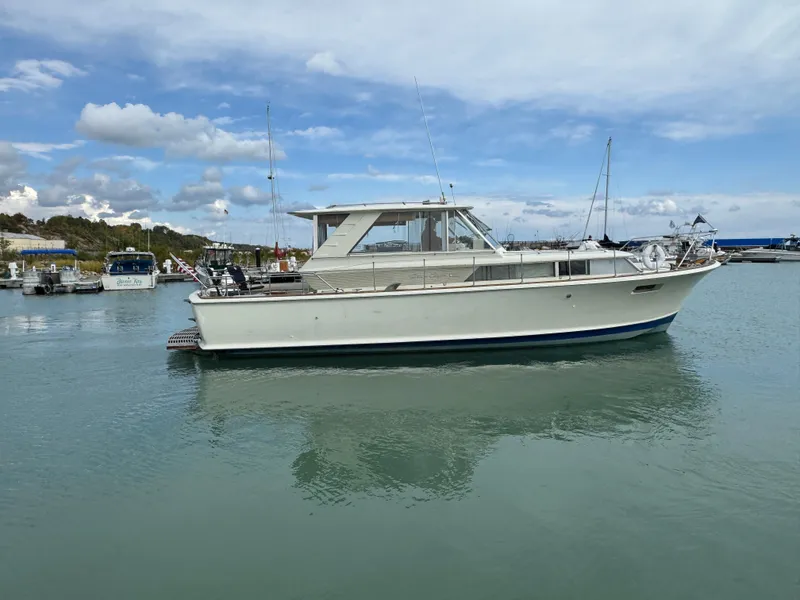 Slide: The Image of 1969 Chris-Craft Commander boat docked in calm marina waters. - 9