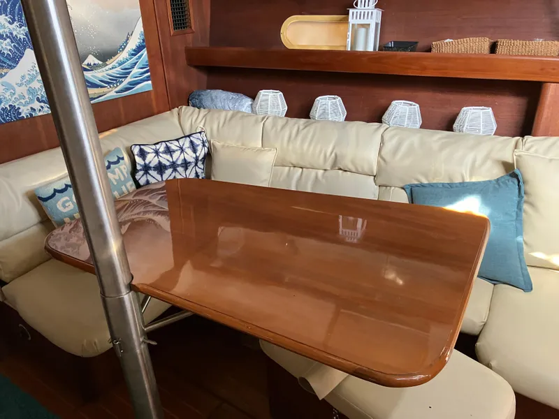 Slide: The Image of Interior of 2001 Hunter Passage 450 yacht with cozy seating and decorative pillows. - 11