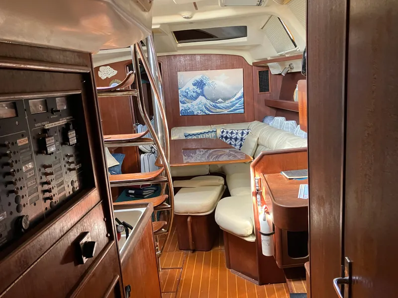 Slide: The Image of Interior of 2001 Hunter Passage 450 yacht with cozy seating and nautical decor. - 13