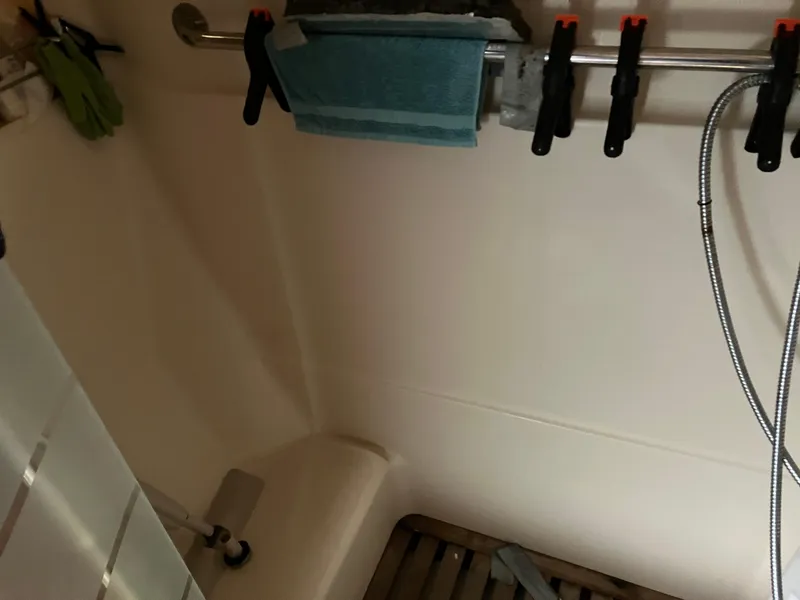 Slide: The Image of Shower area in a 2001 Hunter Passage 450 boat with towel and clamps. - 16