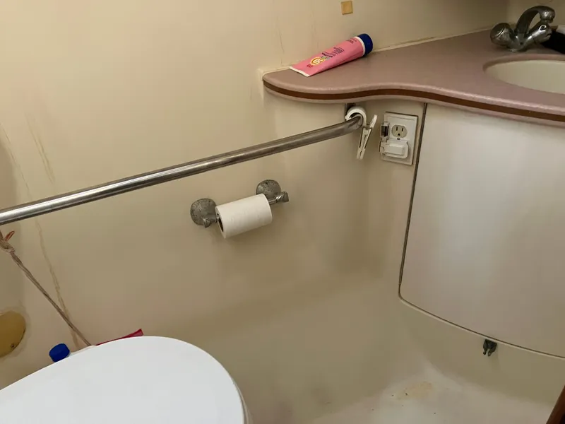 Slide: The Image of Bathroom interior of 2001 Hunter Passage 450 yacht, featuring sink and toilet paper holder. - 17