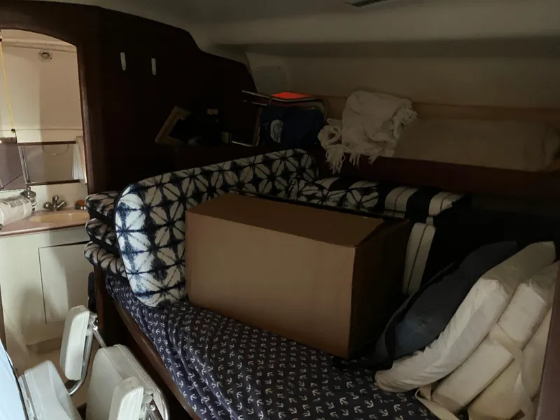Slide: The Image of Cozy cabin interior of 2001 Hunter Passage 450 sailboat with cushions and storage box. - 18